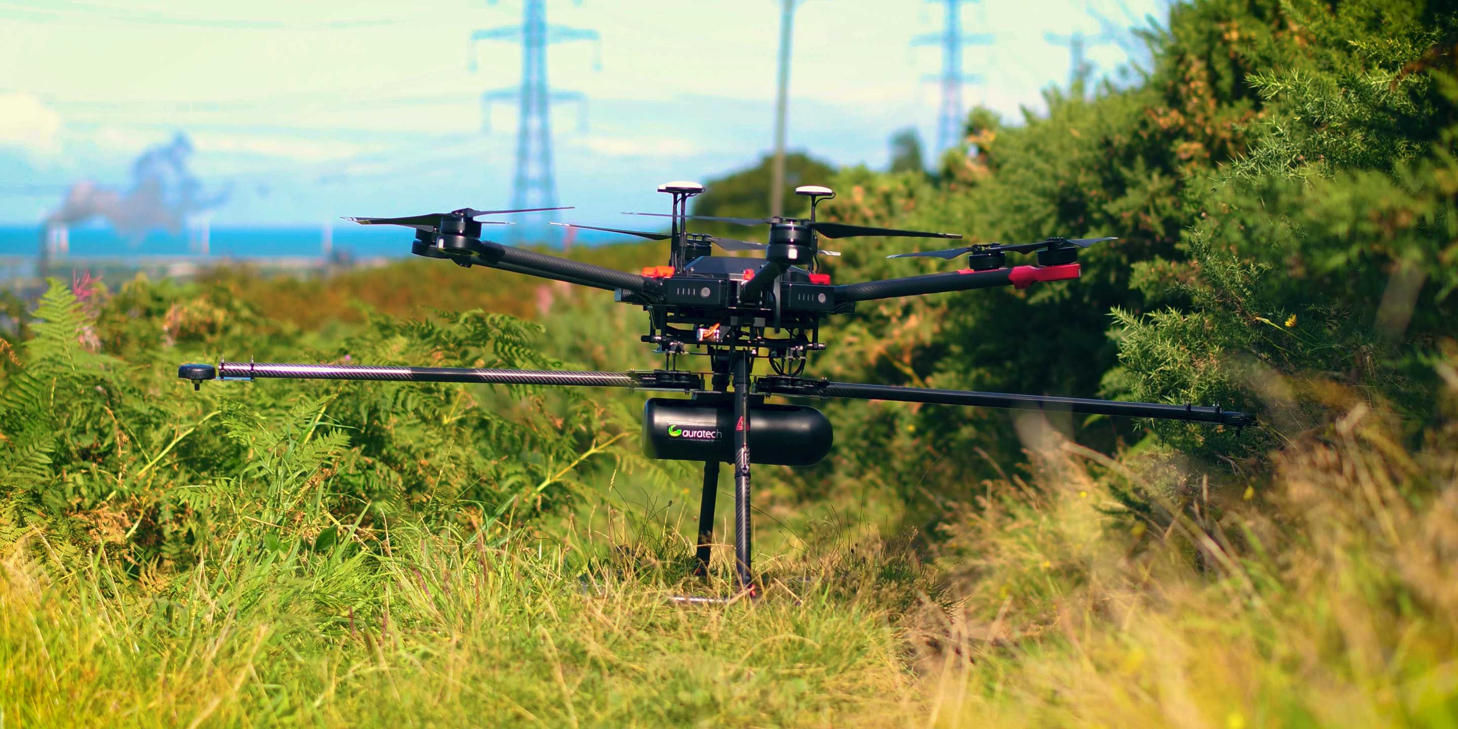 Survey drone with LiDAR payload beside an overhead power line