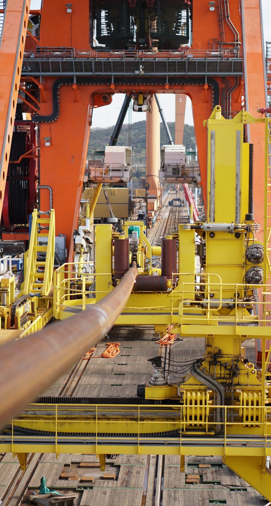 Rigid pipe running through the aligner and tensioner assemblies beneath the pipelay tower